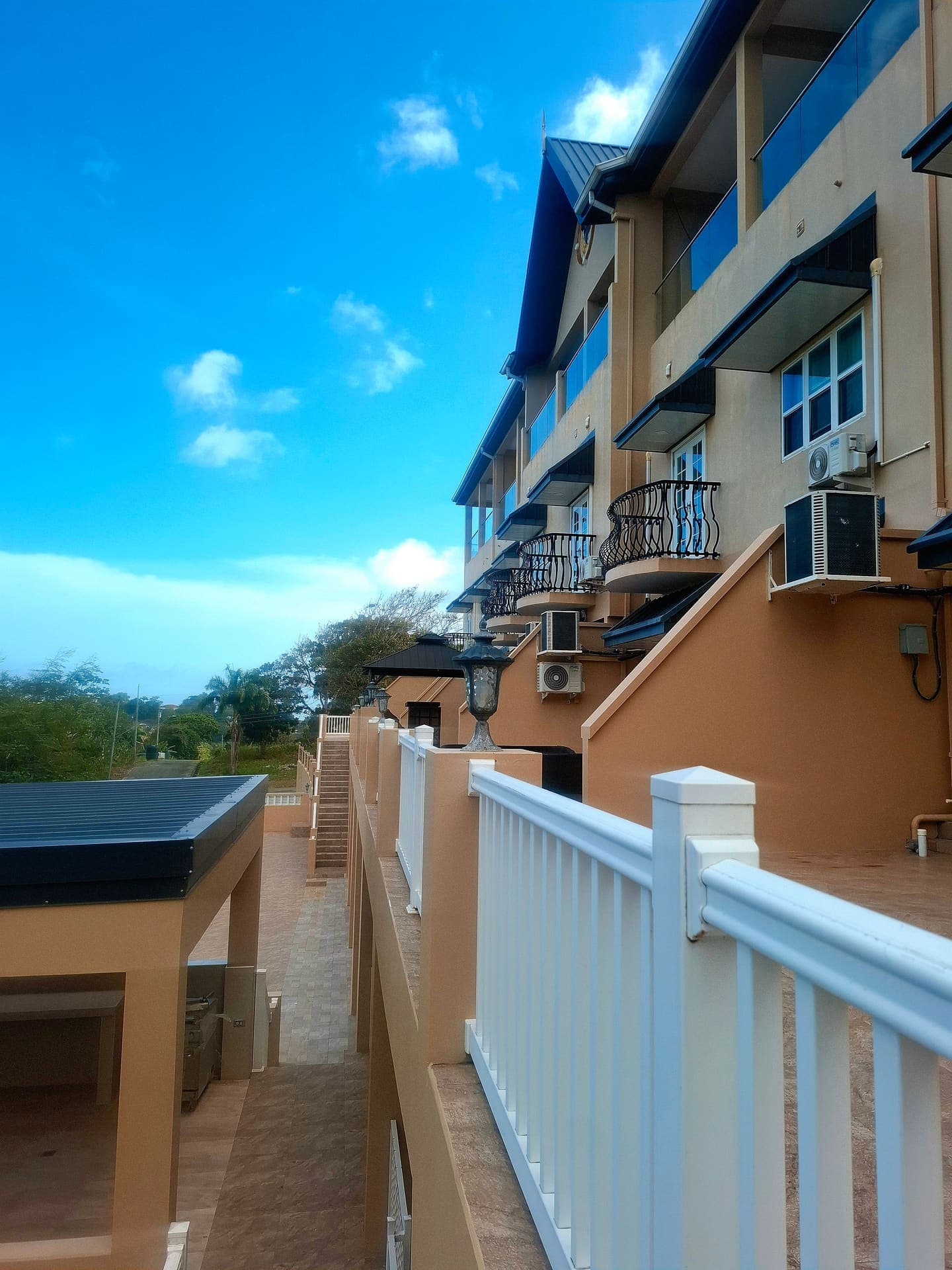 Tropicbird Townhouse exterior with balconies against blue sky